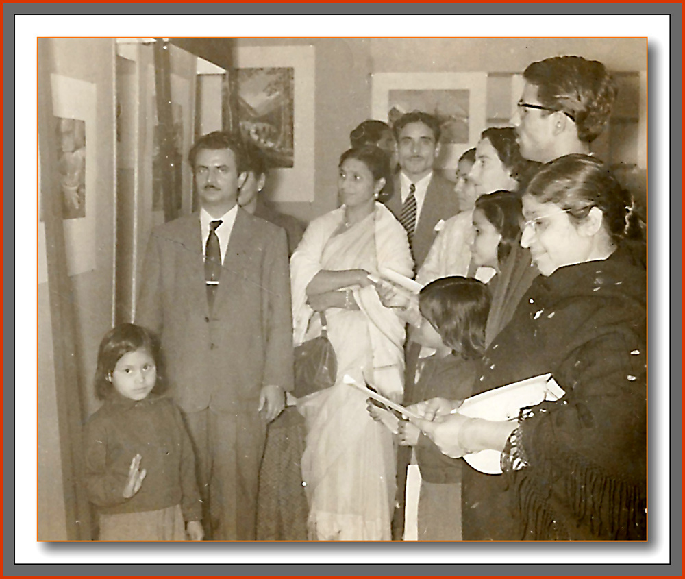 Manohar Kaul with wife Mohini, daughters Usha, Uma, and Suman, and relatives Motilal Kuchroo, Girdehari Lal, and others unidentified, viewing paintings on display at the 1957 exhibition inaugurated by Dr. B. V. Keskar, December 1957